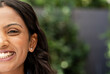 © Wavebreak Media - Indian woman smiling in backyard showing silver stud earrings and denim shirt collar, copy space
