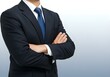 © Autism in Focus - Confident businessman in navy suit crossing arms on clean white and blue background