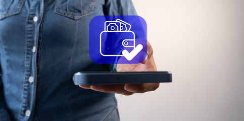 Poster - A woman is holding a smartphone with a digital wallet app icon on the screen, in a close-up view. 
