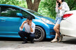 © itchaznong - Insurance Incident. A man distressed while talking on the phone after a car accident.