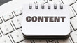 © roobcio - CONTENT word in a small office notebook placed on the keyboard.