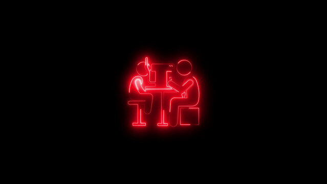 Two people collaborating at a table with a neon red outline design against a black background