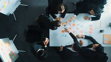 Poster - Top view of investor writing white board to present project and making hand shaking with professional business team to celebrate successful project at meeting table with sticky note. Directorate.