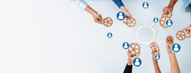 Poster - This image illustrates hands connecting gears, symbolizing teamwork and networking among professionals. It emphasizes the importance of collaboration and shared goals in business settings. Amity