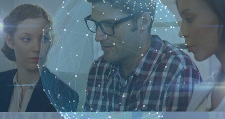 Poster - Collaborating office trio leaning over desk in conference room, with translucent network sphere