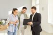 © Studio Romantic - Family couple buying new apartment, listening to advice of real estate agent, estimating home value, discussing design project of house. Happy future homeowners talking with realtor
