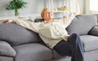 © Studio Romantic - Senior relaxed retired elder pleasant woman resting on new grey soft couch in stylish cozy apartment interior, breathing calm, comfortable in modern living room, smiling to enjoy calm day alone
