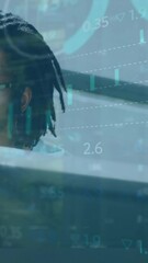 Poster - Animation of infographic interface over african american businessman with dreadlocks using computer