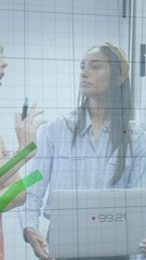 Poster - Animation of green graphs moving against diverse colleagues discussing over whiteboard at office