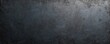 © Maryna - Close-up texture of cast iron plate shows rough, metallic surface with subtle signs of age, wear. Dark grey, almost black, material features uneven, pitted pattern, hinting at industrial origins,