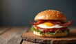 © Maryna - Gourmet breakfast sandwich featuring crispy bacon, fried egg, sausage patty on sesame seed bun. Savory, delicious meal presented on minimalist style wooden board. Artisanal preparation, fresh