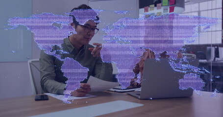 Poster - Reviewing printed documents, Asian man and woman discussing at office table, digital map projection