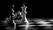 © Unique Image - A monochrome image of a standing white king chess piece with a fallen black king piece nearby