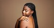 © peopleimages.com - Studio background, shine and woman with smooth skin, treatment and smile for glow and mock up space. Happy, black person and pride for dermatology, beauty and cosmetics for wellness or skincare