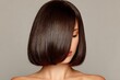 © Adil - Shoulder-Length Bob Haircut From The Back, Featuring A Clean Center Part And Subtle Natural Highlights In Dark Brown Hair. The Bob Has Soft Curves At The Ends And Is Styled With Precision