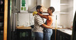 © peopleimages.com - Painting, dance and happy couple in home for love, remodeling and bonding together with care. Renovation, man and African woman with music in kitchen to celebrate house upgrade, romance and embrace