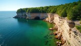 Lake Superior coastline with tranquil beach scene, light brown rocks, dark brown cliffs, clear blue ocean. Scenic landscape of Pictured Rocks National Lakeshore in Michigan. Few people on shoreline Lake Superior coastline with tranquil beach scene, light brown rocks, dark brown cliffs, clear blue ocean. Scenic landscape of Pictured Rocks National Lakeshore in Michigan. Few people on shoreline