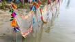 © MuhammadHassaan - Colorful fishing nets and kite decorations on a sunny river