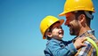 © miss irine - Father and construction worker wear yellow and blue hard hats smiling at each other. Hands rest on hips. Friendly atmosphere at construction site with sunny sky backdrop.