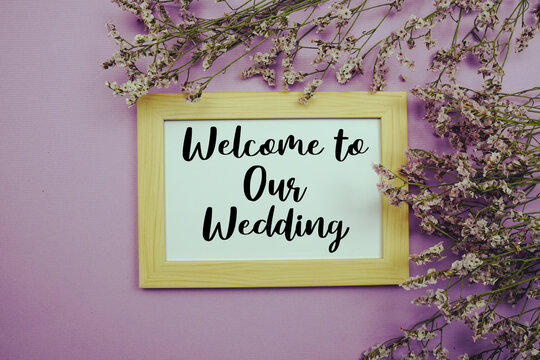 Welcome to Our Wedding text with flowers bouquet decoration on purple background