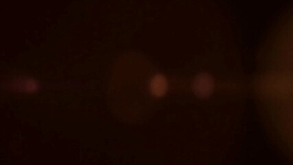 Poster - Abstract dark background with blurred orange and pink bokeh lights creating soft glow effect in darkness
