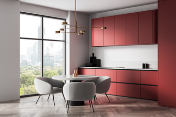 Poster - Modern kitchen interior with red cabinets, round dining table and city view through large window in minimalist design concept. 3D Rendering