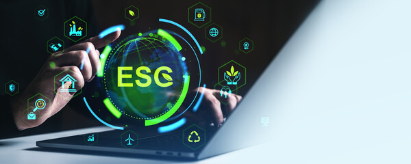 Poster - ESG digital interface concept with glowing sustainability and environmental icons around a globe and hands interacting with laptop on dark background.