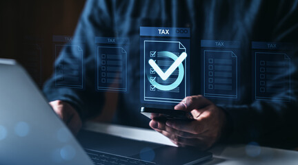 Poster - Digital tax filing concept with person using smartphone and laptop, holographic tax documents with checkmark icons in futuristic interface design..