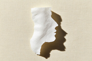 Aufkleber - Torn paper textured surface abstract silhouette human profile shadow minimal style creative concept white beige artistic composition emotional expression