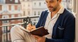 © Ibnan - Man Writing in Notebook on Balcony with City View
