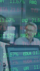 Poster - Animation of stock market data processing over two diverse women discussing over a laptop at office