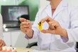 © Kran - Dentist explains dental procedure using tooth model