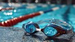 © Daphne - Blue swimming goggles on poolside with blurred water background
