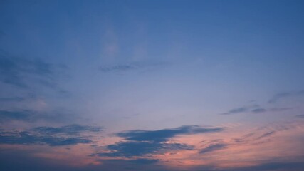 Wall Mural - A tranquil sunset sky timelapse with soft pink and blue hues blending gently, wispy clouds scattered across the sky, evoking calmness as daylight fades into evening’s embrace. Time-lapse.
