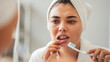 © sebra - Young woman looking at her red bleeding gums