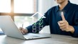 © PixelNest - Individual completes an online house checklist using a laptop computer. A hand shows a thumbs up gesture, signifying positive real estate selection.