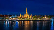 © F16-ISO100 - Bangkok wonderful night view of Wat Arun temple beautifully illuminated on the Chao Phraya River with glowing reflections and city lights in the background