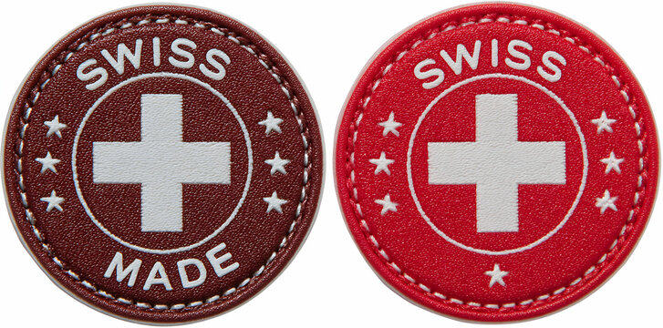 Two Distinct Round Leather Patches Featuring Swiss Made Emblems with Cross on White Background
