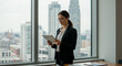 © Mostafizar - Focused Businesswoman Using Digital Tablet in Modern Office with City Skyline View