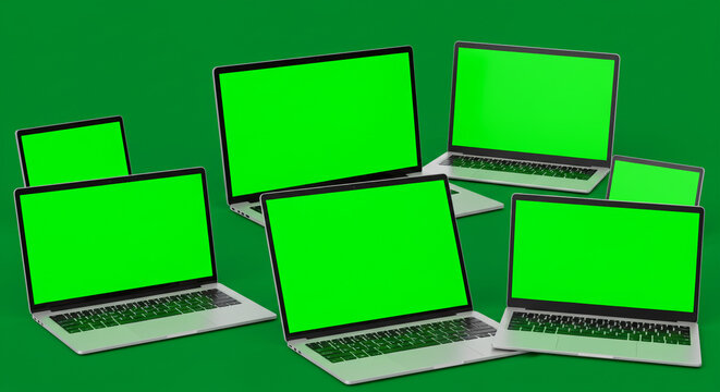 Many laptops with green screens arranged on a green background in a studio environment setting
