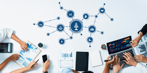Poster - A dynamic business meeting setting featuring professionals collaborating on data analysis and strategies. Emphasizes teamwork and innovation in a corporate workspace. Amity