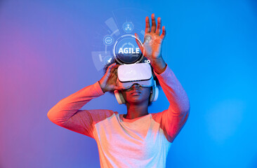 Poster - A person interacts with virtual reality technology, exploring agility concepts amidst a vibrant blue and pink backdrop, highlighting innovation and modern engagement. XDMCP