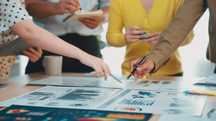 Poster - A vibrant business meeting showcasing diverse professionals collaborating over charts and data in a modern office setting, emphasizing teamwork and communication. SACTR