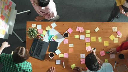 Poster - Top view of skilled business people discuss plan at meeting room while writing idea at sticky notes and stick at whiteboard. Group of diverse team working together to planning strategy. Convocation.