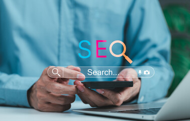 Wall Mural - seo search engine optimization digital marketing concept. man using phone with seo letters and searc