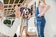 © Marko Geber - Grandparents and grandchildren playing and having fun together on a balcony of their house