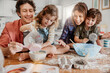 © Marko Geber - Young caucasian family being messy and having fun baking together in the kitchen
