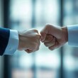 © charlie - colleagues bumping fists after meeting in conference room, natural window light, , corporate stock
