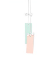 Poster - Elegant paper tags with pastel colors suspended by delicate white ribbons and bows on a clean white background