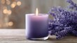 © adinuranjaya - A scented lavender candle provides relaxing aromatherapy for wellness and comfort